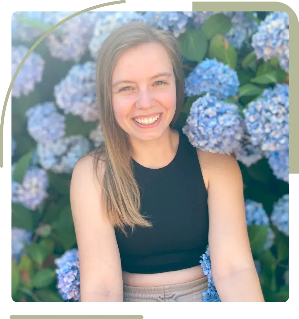 Courtney sitting in front of hydrangeas